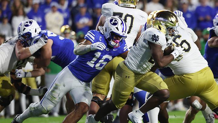Oct 17, 2026; Provo, Utah, USA;  Notre Dame Fighting Irish running back Jonaz Walton (20) runs against Brigham Young Cougars linebacker Isaiah Glasker (16) during the second half at LaVell Edwards Stadium.  Mandatory Credit: Rob Gray-Imagn Images