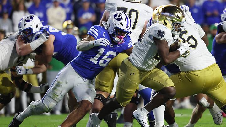 Oct 17, 2026; Provo, Utah, USA;  Notre Dame Fighting Irish running back Jonaz Walton (20) runs against Brigham Young Cougars linebacker Isaiah Glasker (16) during the second half at LaVell Edwards Stadium.  Mandatory Credit: Rob Gray-Imagn Images