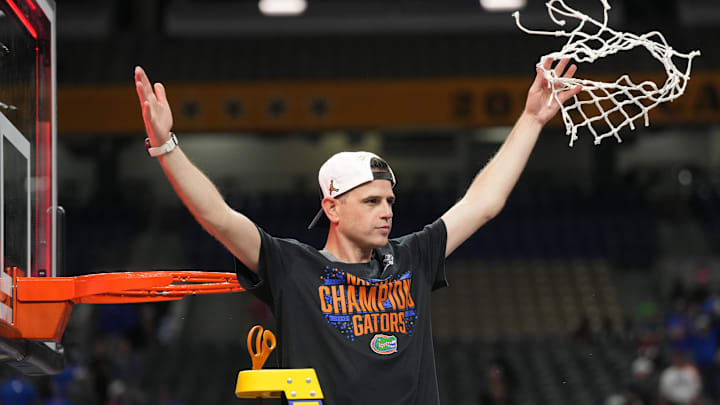 Apr 7, 2025; San Antonio, TX, USA;  Florida Gators head coach Todd Golden cuts down the net after defeating the Houston Cougars in the national championship game of the Final Four of the 2025 NCAA Tournament at the Alamodome. Mandatory Credit: Robert Deutsch-Imagn Images
