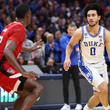 Mar 31, 2024; Dallas, TX, USA; Duke Blue Devils guard Jared McCain (0) controls the ball against North Carolina State Wolfpack forward Mohamed Diarra (23) in the first half in the finals of the South Regional of the 2024 NCAA Tournament at American Airline Center. 
