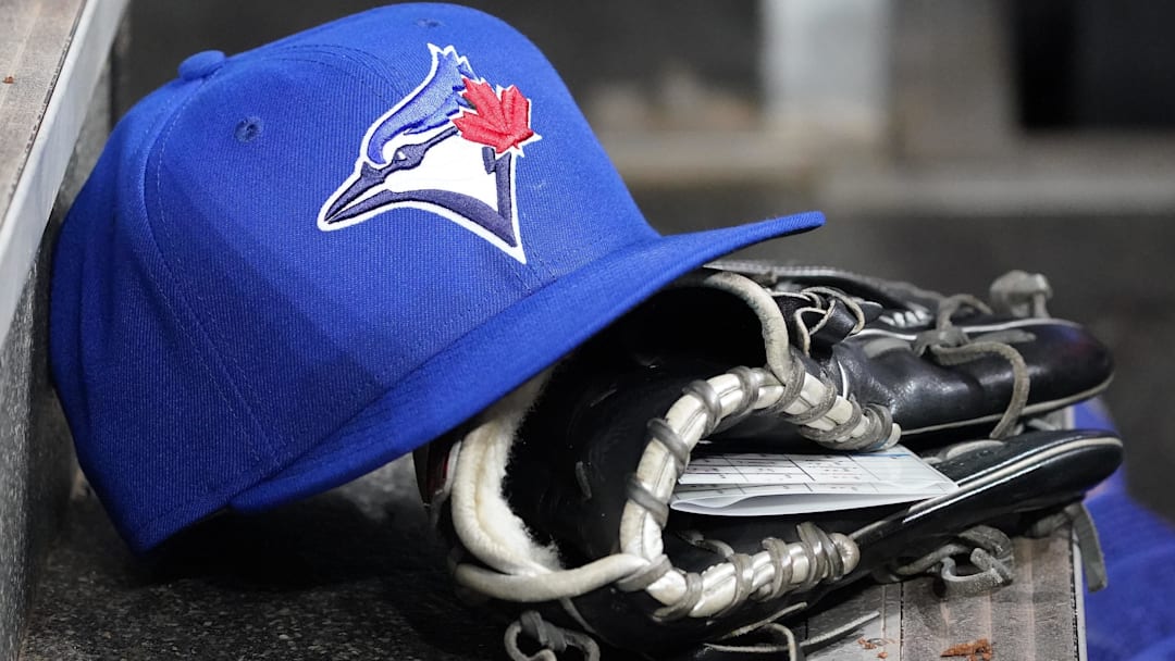 Apr 16, 2025; Toronto, Ontario, CAN; A Toronto Blue Jays hat and glove in the dugout during a game against the Atlanta Braves at Rogers Centre. 