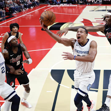 Nov 3, 2023; Portland, Oregon, USA; Memphis Grizzlies shooting guard Desmond Bane (22) drives to the basket under pressure from Portland Trail Blazers center Robert Williams III (35) during the second half at Moda Center. Mandatory Credit: Soobum Im-Imagn Images