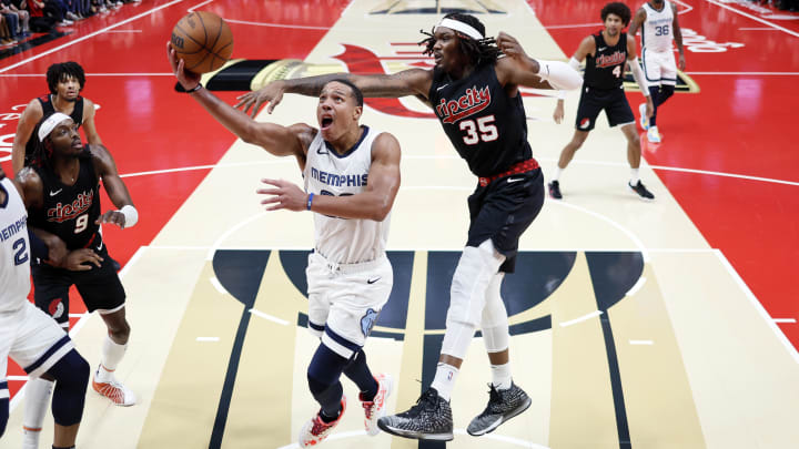 Nov 3, 2023; Portland, Oregon, USA; Memphis Grizzlies shooting guard Desmond Bane (22) drives to the basket under pressure from Portland Trail Blazers center Robert Williams III (35) during the second half at Moda Center. Mandatory Credit: Soobum Im-USA TODAY Sports