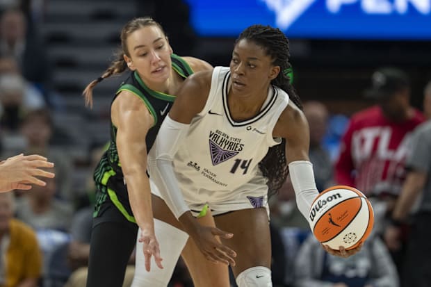 Golden State Valkyries center Temi Fagbenle holds the ball away from Minnesota Lynx forward Alanna Smith. 