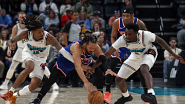 Feb 28, 2025; Memphis, Tennessee, USA; New York Knicks guard Jalen Brunson (middle), Memphis Grizzlies guard Ja Morant (12) and guard Vince Williams Jr. (5) battle for a loose ball during the fourth quarter at FedExForum. Mandatory Credit: Petre Thomas-Imagn Images