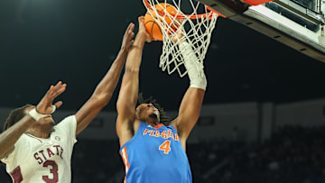 Feb 11, 2025; Starkville, Mississippi, USA; Florida Gators forward Sam Alexis (4) dunks the ball against Mississippi State Bulldogs forward KeShawn Murphy (3) during the first half at Humphrey Coliseum. Mandatory Credit: Wesley Hale-Imagn Images