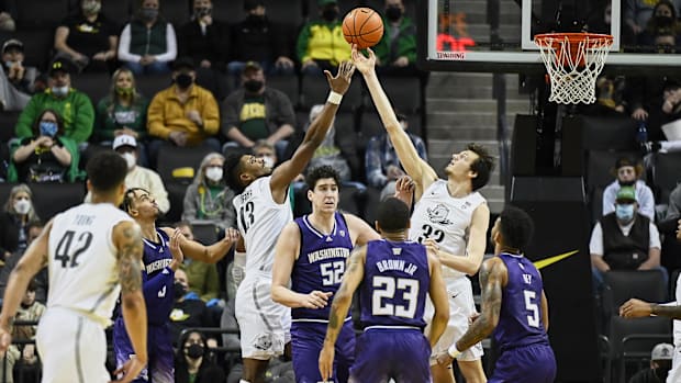 Oregon Ducks forward Quincy Guerrier (13) and center Nate Bittle (32) scramble for a rebound during the second half