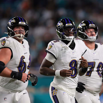 Oct 30, 2025; Miami Gardens, Florida, USA; Baltimore Ravens quarterback Lamar Jackson (8) runs up to the line with center Tyler Linderbaum (64) and offensive tackle Roger Rosengarten (70) during the third quarter against the Miami Dolphins at Hard Rock Stadium. Mandatory Credit: Sam Navarro-Imagn Images