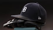 Jul 30, 2021; Detroit, Michigan, USA; The hat and glove of Detroit Tigers right fielder Robbie Grossman (8) sits on the ledge of the dugout during the first inning against the Baltimore Orioles at Comerica Park. Mandatory Credit: Raj Mehta-Imagn Images