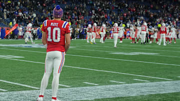 Drake Maye watches from the sidelines during latest Patriots' victory.
