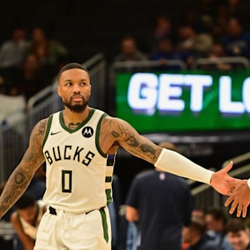 Oct 20, 2023; Milwaukee, Wisconsin, USA; Milwaukee Bucks guard Damian Lillard (0) greets forward Giannis Antetokounmpo (34) during game against the Memphis Grizzlies at Fiserv Forum. Mandatory Credit: Benny Sieu-Imagn Images