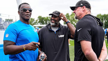 Former Lions player Robert Porcher, left, talks to general manager Brad Holmes, center, and head coach Dan Campbell after practice at training camp at Meijer Performance Center in Allen Park on Thursday, August 21, 2025.