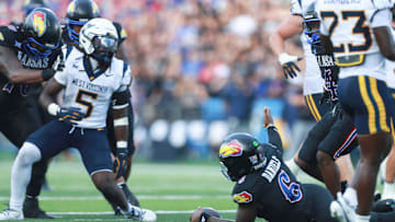 Kansas Jayhawks quarterback Jalon Daniels (6) questions officials after a running play during the first half of the game against West Virginia Mountaineers at David Booth Kansas Memorial Stadium on Sept. 20, 2025.