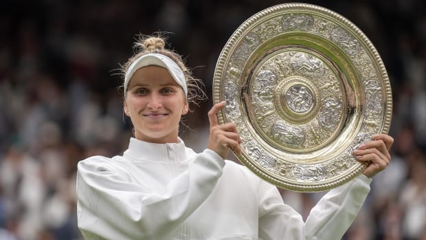 Vondrousova poses with her 2023 Wimbledon trophy.