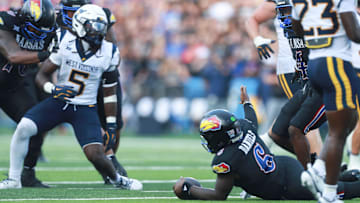 Kansas Jayhawks quarterback Jalon Daniels (6) questions officials after a running play during the first half of the game against West Virginia Mountaineers at David Booth Kansas Memorial Stadium on Sept. 20, 2025.