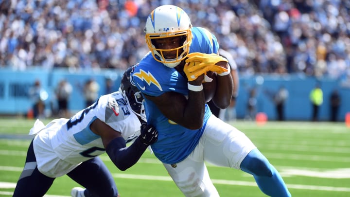 Sep 17, 2023; Nashville, Tennessee, USA; Los Angeles Chargers wide receiver Mike Williams (81) runs after a catch against Tennessee Titans cornerback Tre Avery (23) during the first half at Nissan Stadium.