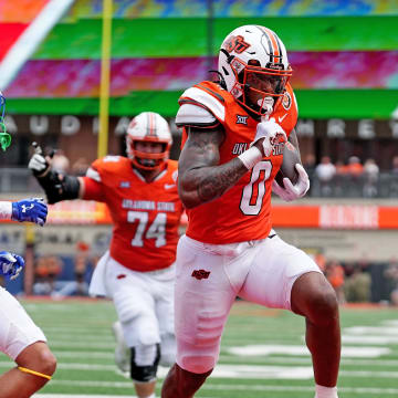 Oklahoma State's Ollie Gordon II (0) scores a touchdown in the first half of the college football game between the Oklahoma State Cowboys and South Dakota State Jackrabbits at Boone Pickens Stadium in Stillwater, Okla., Saturday, Aug., 31, 2024.