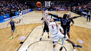 Mar 22, 2025; Denver, CO, USA; Wisconsin Badgers guard John Tonje (9) drives to the net against Brigham Young Cougars center Keba Keita (13) as guard Egor Demin (3) and guard Trey Stewart (1) defend in the first half at Ball Arena. Mandatory Credit: Isaiah J. Downing-Imagn Images