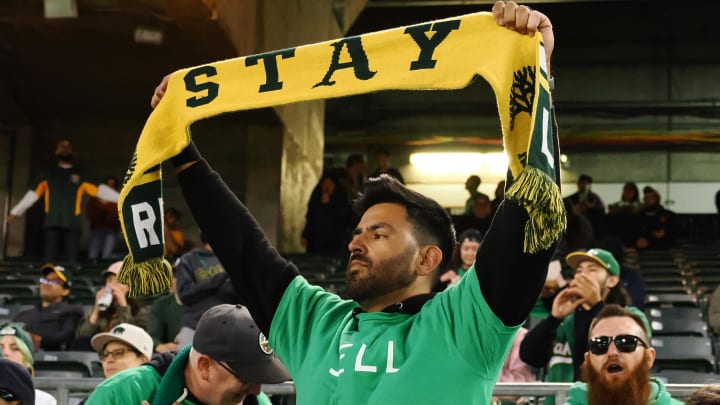 Apr 28, 2023; Oakland, California, USA; An Oakland Athletics fan holds a scarf during the sixth inning against the Cincinnati Reds at Oakland Coliseum. Mandatory Credit: Kelley L Cox-USA TODAY Sports