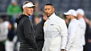 Oct 14, 2023; South Bend, Indiana, USA; USC Trojans head coach Lincoln Riley and Notre Dame Fighting Irish head coach Marcus Freeman chat before the game at Notre Dame Stadium. Mandatory Credit: Matt Cashore-Imagn Images