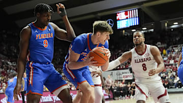 Mar 5, 2025; Tuscaloosa, AL, USA;  Florida forward Alex Condon (21) grabs a rebound between Florida center Rueben Chinyelu (9) and Alabama guard Chris Youngblood (8) at Coleman Coliseum. Mandatory Credit: Gary Cosby Jr./USA TODAY Network via Imagn Images