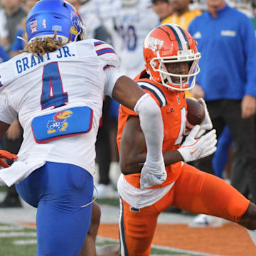 Sep 7, 2024; Champaign, Illinois, USA; Illinois Fighting Illini wide receiver Zakhari Franklin (4) runs for a first down as Kansas Jayhawks safety Marvin Grant (4) pursues during the first half at Memorial Stadium. Mandatory Credit: Ron Johnson-Imagn Images