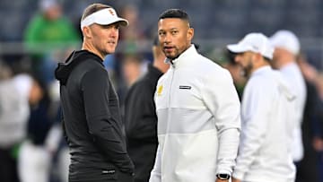 Oct 14, 2023; South Bend, Indiana, USA; USC Trojans head coach Lincoln Riley and Notre Dame Fighting Irish head coach Marcus Freeman chat before the game at Notre Dame Stadium. Mandatory Credit: Matt Cashore-Imagn Images