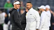 Oct 14, 2023; South Bend, Indiana, USA; USC Trojans head coach Lincoln Riley and Notre Dame Fighting Irish head coach Marcus Freeman chat before the game at Notre Dame Stadium. Mandatory Credit: Matt Cashore-Imagn Images