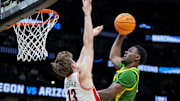 Mar 23, 2025; Seattle, WA, USA;  Arizona Wildcats forward Henri Veesaar (13) fouls as Oregon Ducks guard TJ Bamba (5) drives to the basket in the second half at Climate Pledge Arena. Mandatory Credit: Stephen Brashear-Imagn Images