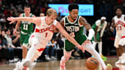 Oct 10, 2025; Toronto, Ontario, CAN;  Toronto Raptors forward Gradey Dick (1) knocks the ball away from Boston Celtics guard Anfernee Simons (4) in the second half at Scotiabank Arena. Mandatory Credit: Dan Hamilton-Imagn Images