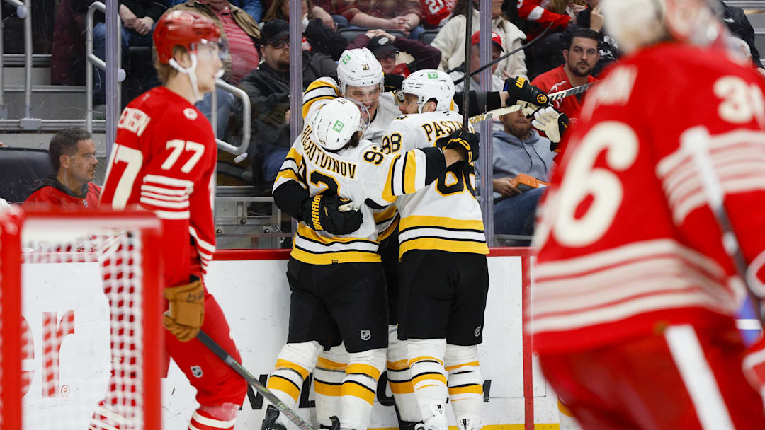Mar 21, 2026; Detroit, Michigan, USA; Boston Bruins defenseman Nikita Zadorov (91) celebrates with right wing David Pastrnak (88) and center Marat Khusnutdinov (92) after scoring a goal in the third period against the Detroit Red Wings at Little Caesars Arena. Mandatory Credit: Brian Bradshaw Sevald-Imagn Images