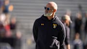 Navy coach Brian Newberry stands before the Armed Forces Bowl football game between the University of Oklahoma Sooners (OU) and the Navy Midshipmen at Amon G. Carter Stadium in Fort Worth, Texas, Friday, Dec. 27, 2024.