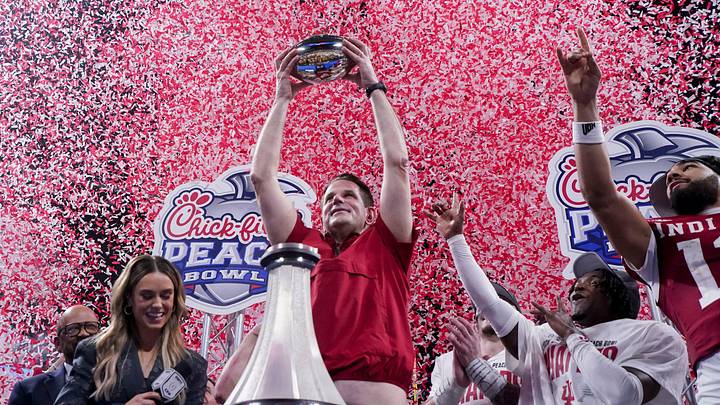 Indiana Hoosiers head coach Curt Cignetti holds up the trophy as confetti falls Friday, Jan. 9, 2026, after defeating the Oregon Ducks in the Peach Bowl and semifinal game of the College Football Playoff at Mercedes-Benz Stadium in Atlanta.