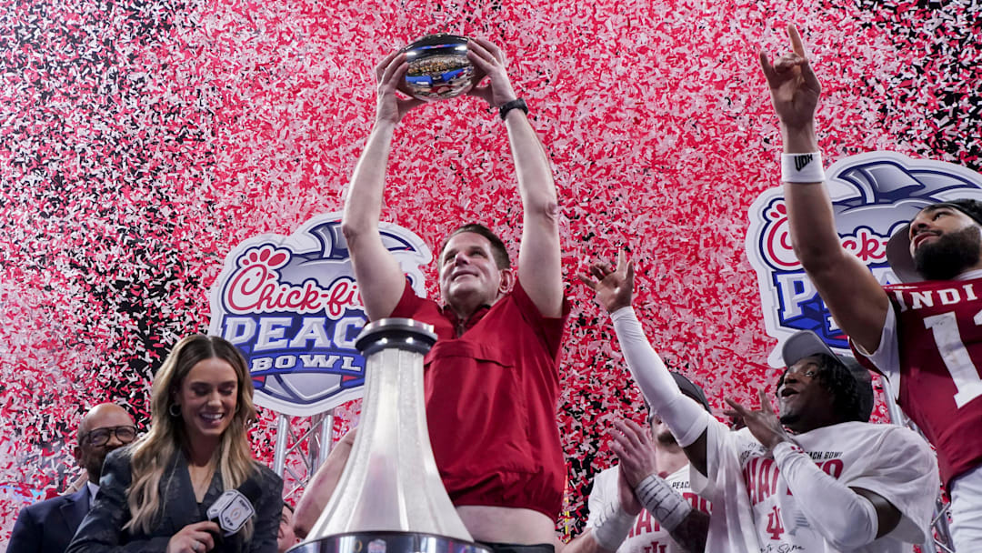 Indiana Hoosiers head coach Curt Cignetti holds up the trophy as confetti falls Friday, Jan. 9, 2026, after defeating the Oregon Ducks in the Peach Bowl and semifinal game of the College Football Playoff at Mercedes-Benz Stadium in Atlanta.