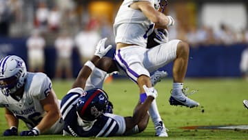 Aug 31, 2024; Oxford, Mississippi, USA; Furman Paladins wide receiver Colton Hinton (1) spins away from a tackle attempt by Mississippi Rebels defensive back Louis Moore (7) during the first half at Vaught-Hemingway Stadium. Mandatory Credit: Petre Thomas-Imagn Images