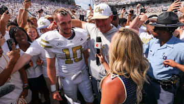 Sep 13, 2025; Atlanta, Georgia, USA; Georgia Tech Yellow Jackets quarterback Haynes King (10) and head coach Brent Key talk to a reporter after a victory over the Clemson Tigers at Bobby Dodd Stadium at Hyundai Field. Mandatory Credit: Brett Davis-Imagn Images