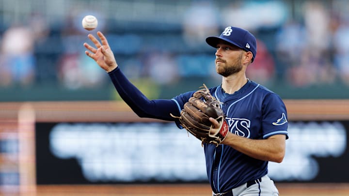 Jun 25, 2025; Kansas City, Missouri, USA;  Tampa Bay Rays second baseman Brandon Lowe (8) throws to first base during the fourth inning against the Kansas City Royals at Kauffman Stadium. Mandatory Credit: William Purnell-Imagn Images