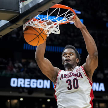 Mar 23, 2025; Seattle, WA, USA;  Arizona Wildcats forward Tobe Awaka (30) dunks the ball against the Oregon Ducks in the first half at Climate Pledge Arena. Mandatory Credit: Stephen Brashear-Imagn Images