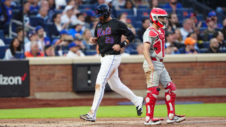 May 13, 2024; New York City, New York, USA; New York Mets designated hitter JD Martinez (28) scores a run on New York Mets catcher Tomas Nido (not pictured) RBI single against the Philadelphia Phillies during the second inning at Citi Field. Mandatory Credit: Gregory Fisher-USA TODAY Sports