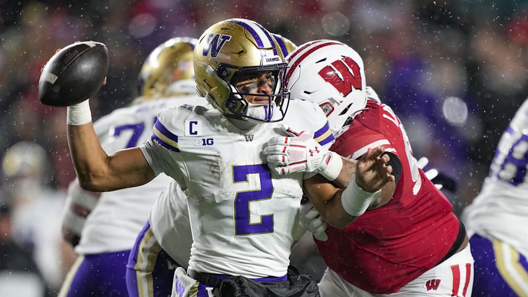 Nov 8, 2025; Madison, Wisconsin, USA; Washington Huskies quarterback Demond Williams Jr. (2) throws the ball away under pressure from Wisconsin Badgers defensive lineman Brandon Lane Jr. (95) during the third quarter at Camp Randall Stadium. Mandatory Credit: Jeff Hanisch-Imagn Images Nov 8, 2025; Madison, Wisconsin, USA; Washington Huskies quarterback Demond Williams Jr. (2) throws the ball away under pressure from Wisconsin Badgers defensive lineman Brandon Lane Jr. (95) during the third quarter at Camp Randall Stadium. Mandatory Credit: Jeff Hanisch-Imagn Images