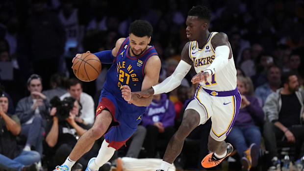 Denver Nuggets goalkeeper Jamal Murray (27) controls the ball against the Los Angeles Lakers Dennis Schroder (17) goalkeeper (17)