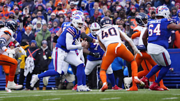 Jan 12, 2025; Orchard Park, New York, USA; Buffalo Bills quarterback Josh Allen (17) runs for a gain during the second quarter against the Denver Broncos in an AFC wild card game at Highmark Stadium. Mandatory Credit: Gregory Fisher-Imagn Images