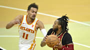 Nov 28, 2023; Cleveland, Ohio, USA; Atlanta Hawks guard Trae Young (11) defends Cleveland Cavaliers guard Darius Garland (10) in the fourth quarter at Rocket Mortgage FieldHouse. Mandatory Credit: David Richard-Imagn Images