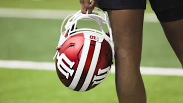 A player holds an Indiana helmet during fall camp on Aug. 1.