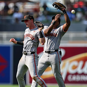 Sep 8, 2024; San Diego, California, USA; San Francisco Giants shortstop Tyler Fitzgerald (49), left, and second baseman Marco Luciano (37) collide while trying to catch a fly ball from San Diego Padres left fielder Jurickson Profar (not pictured) during the seventh inning at Petco Park.