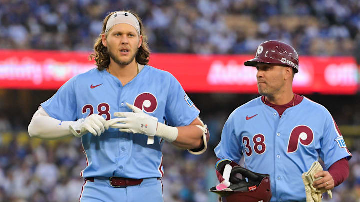 Oct 8, 2025; Los Angeles, California, USA; Philadelphia Phillies third baseman Alec Bohm (28) walks off the field with Philadelphia Phillies first base coach Paco Figueroa (38) after a line out during the first inning against the Los Angeles Dodgers during game three of the NLDS round for the 2025 MLB playoffs at Dodger Stadium. Mandatory Credit: Jayne Kamin-Oncea-Imagn Images