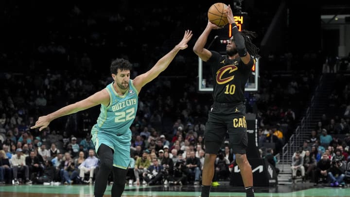 Mar 27, 2024; Charlotte, North Carolina, USA; Cleveland Cavaliers guard Darius Garland (10) shoots a jumper against Charlotte Hornets guard Vasa Micic (22) during the first quarter at Spectrum Center. Mandatory Credit: Jim Dedmon-USA TODAY Sports