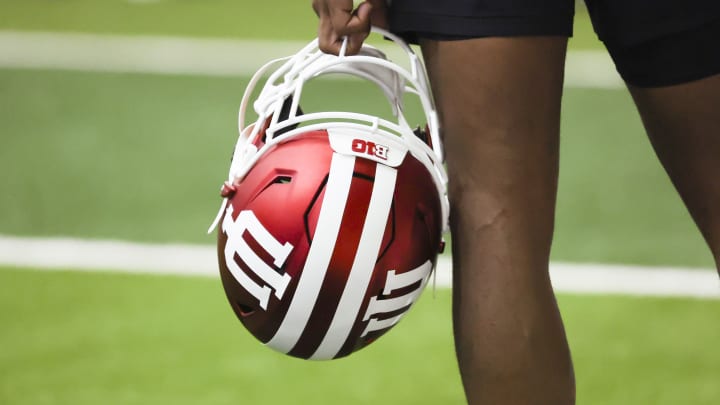 A player holds an Indiana helmet during fall camp on Aug. 1.