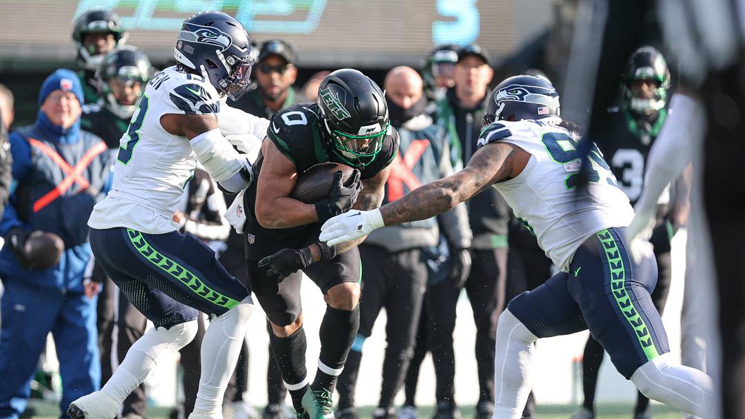 Dec 1, 2024; East Rutherford, New Jersey, USA; New York Jets running back Braelon Allen (0) is tackled by Seattle Seahawks linebacker Ernest Jones IV (13) and defensive end Leonard Williams (99) during the first half at MetLife Stadium. Mandatory Credit: Vincent Carchietta-Imagn Images