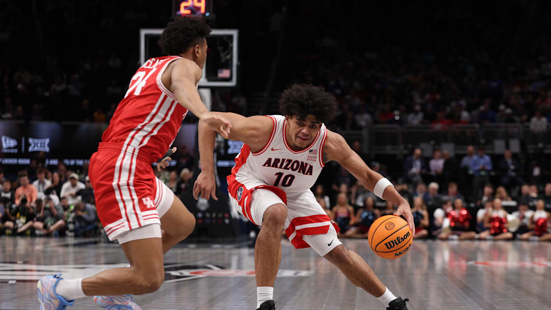 Mar 14, 2026; Kansas City, MO, USA; Arizona Wildcats forward Koa Peat (10) drives to the hoop past Houston Cougars forward Chase McCarty (24) during the first half during the men's Big 12 Conference Tournament Championship at T-Mobile Center. Mandatory Credit: William Purnell-Imagn Images